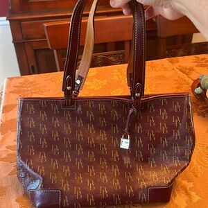 Dooney & Bourke 16”x9.25” burgundy with gold letters. Good condition